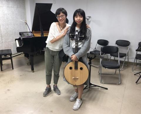 Winni老師音樂教學 - 照片左邊的是知名爵士鋼琴師彭郁雯，除了樂團外也常與各個專業領域合作，此照片是爵士與彈撥樂團合作時拍攝，右邊手中的樂器為中阮。