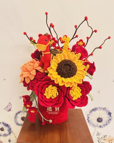 云云 - ? 《進寶・向陽招財鉤織花藝》 ?

最近完成了一盆充滿喜氣的鉤織花藝。

我很喜歡在作品裡藏一點小驚喜，
這次悄悄加入了一隻紅色馬，
希望看到它的人，都能感覺到今年馬年的好運。

手作的過程很慢，
一針一線的鉤，
也一點一點把心意放進去。
願這份不會凋謝的花，
收到這組花筒的朋友也能替你留住溫暖、喜氣與進寶的祝福。

如果你也喜歡這樣的作品，
歡迎留言跟我說你最喜歡哪一朵花 ?